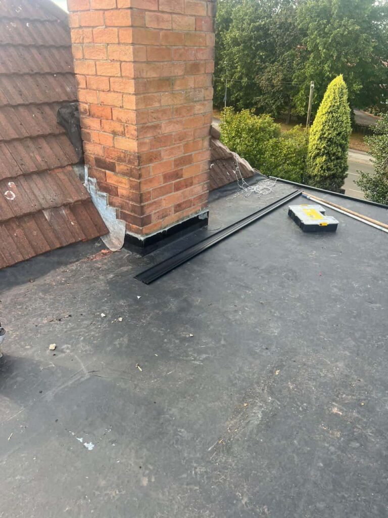 This is a photo of a flat roof which has just been repaired, there is also a chimney stack and some leadwork has also been dressed. Works carried out by Ruddington Roofing Repairs